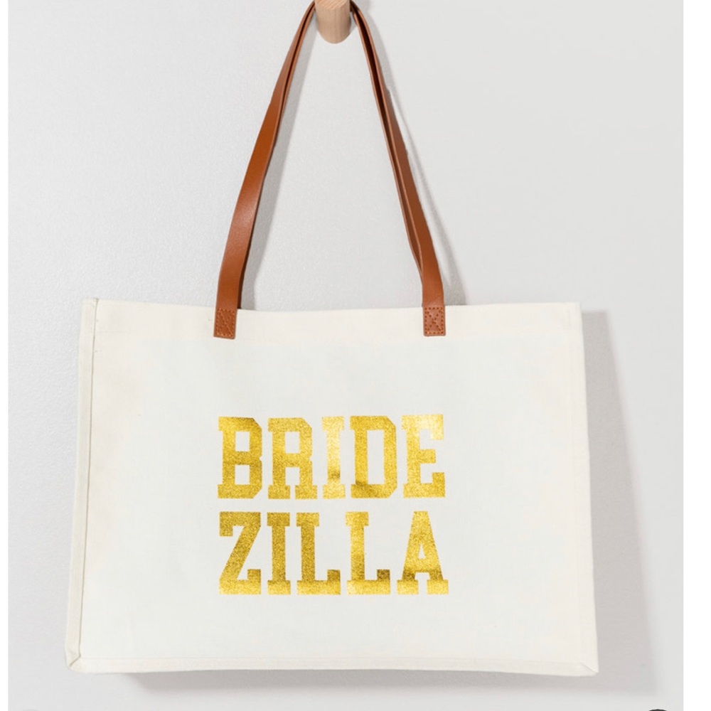 Tote Bag
- Canvas With Graphic
- Gold Print Script On Front